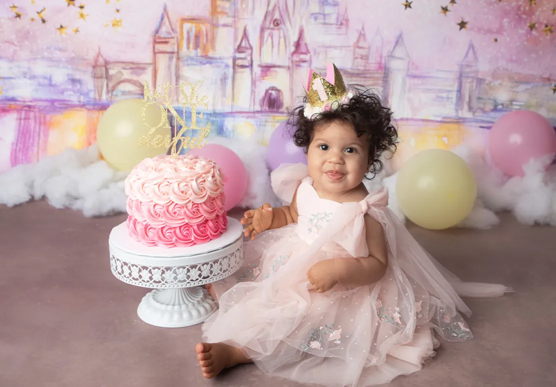 Baby girl, toddler, on her first birthday cake smash